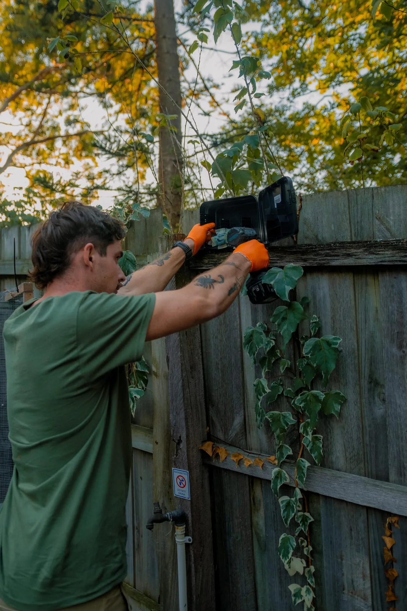 Installing a lockable bait station on a fence line